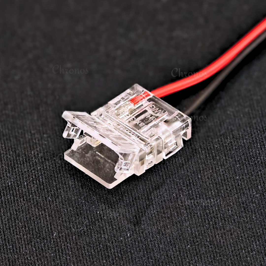 Close-up view of Chronos Lights LED strip connector with copper contacts.