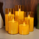Decorative golden LED moving flame pillar candle for parties, corporate events, and festive setups