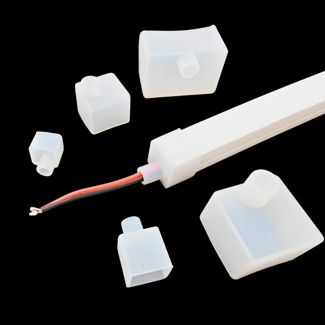 Silicone end caps for LED strip channel with metal mounting clips.
