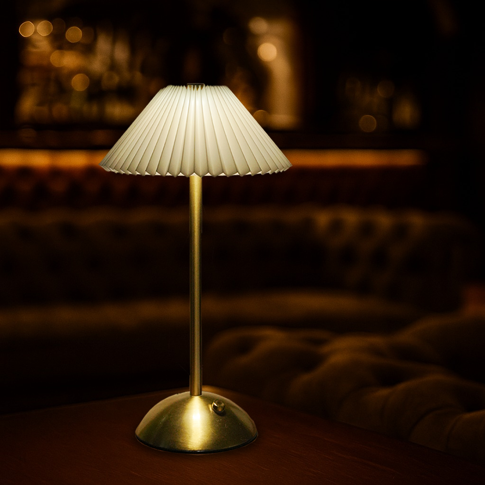 Velora cordless rechargeable table lamp with brushed brass base and pleated fabric shade