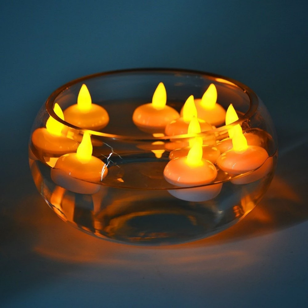 Floating LED tea light candles with warm ambient glow on water