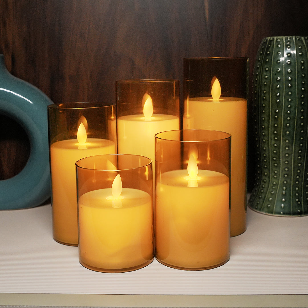 Luxurious acrylic golden glass LED moving flame pillar candle for home decor.