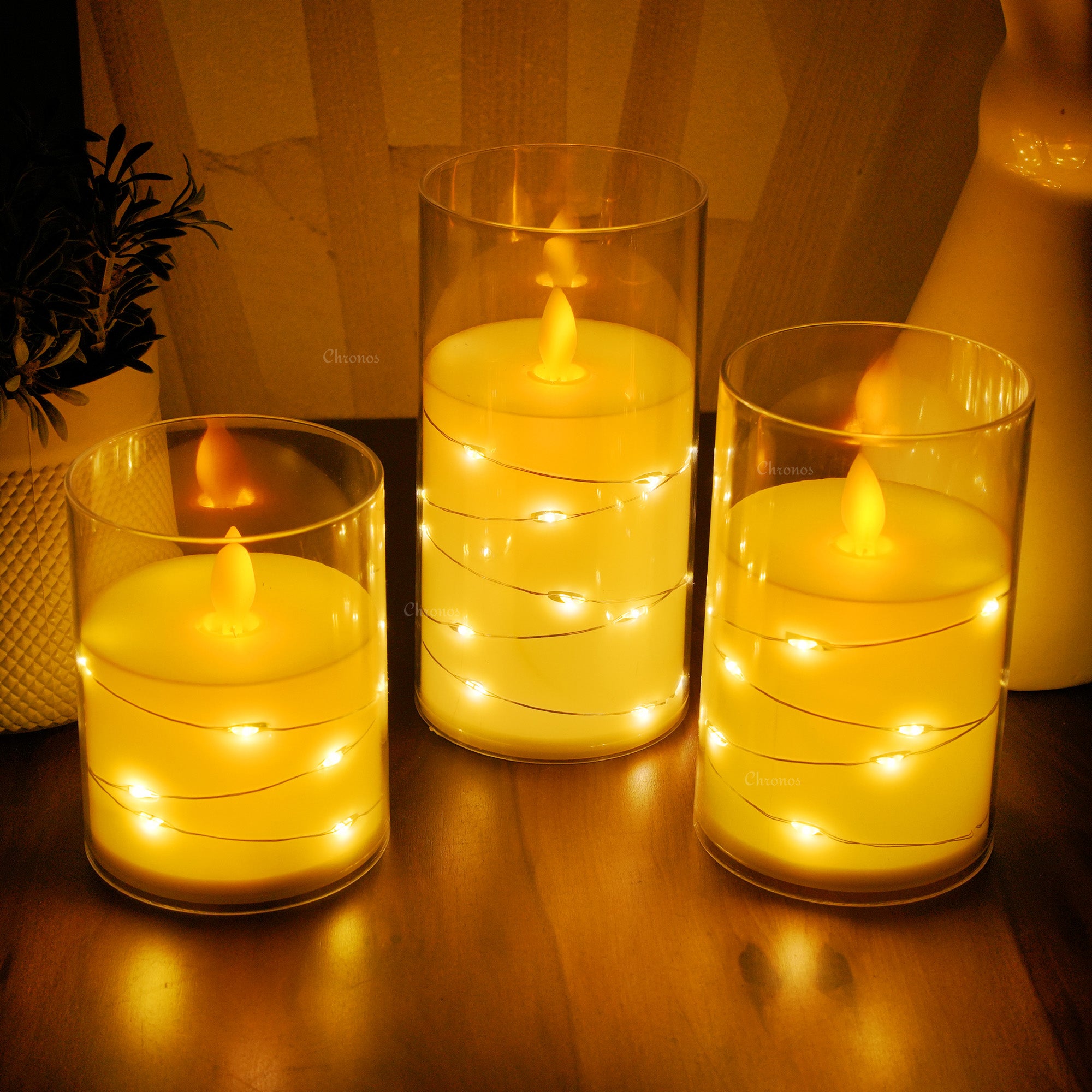 Acrylic glass LED moving flame pillar candle with fairy lights, perfect for festive decor.