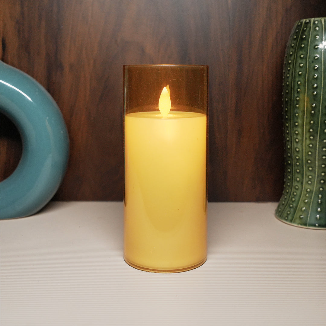 Battery-operated golden glass LED candle for festive ambiance.