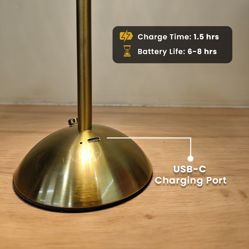 Gold lamp with USB-C charging port on a wooden surface