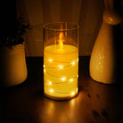 Battery-operated flameless candle with enchanting flickering flame and embedded fairy lights.