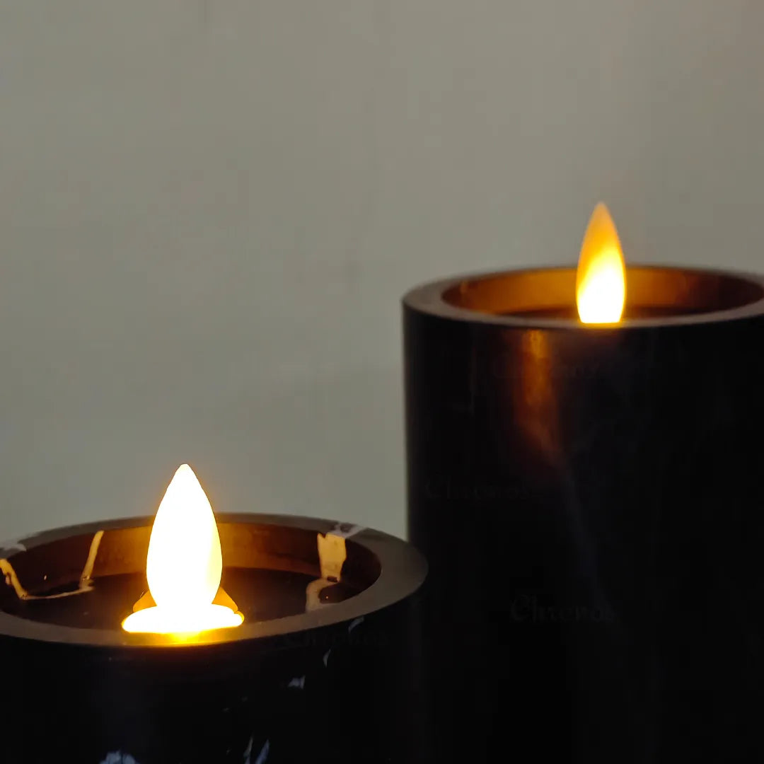 Close-up view of moving wick flame on marble noir LED candle