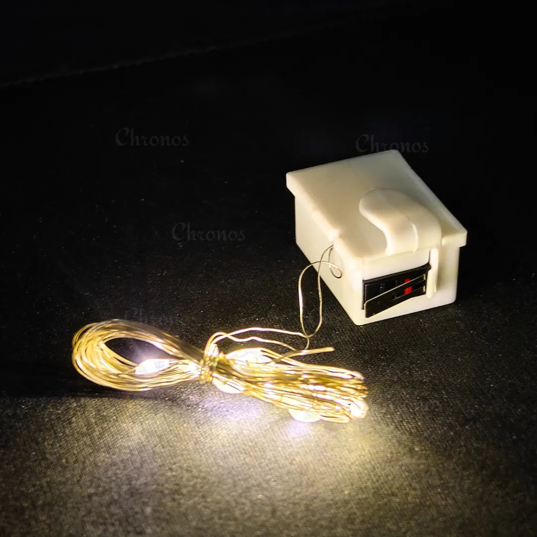 Seasonal gifting box decorated with warm white LED fairy lights using hook.