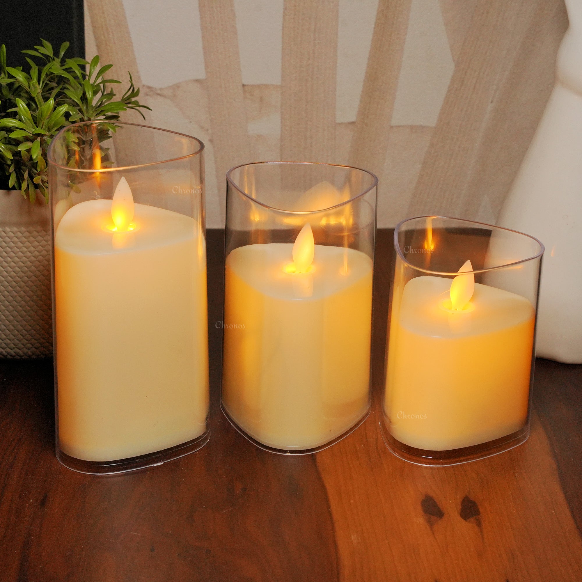 Acrylic glass LED moving flame pillar candle available in classic and triangular shapes for home decor.