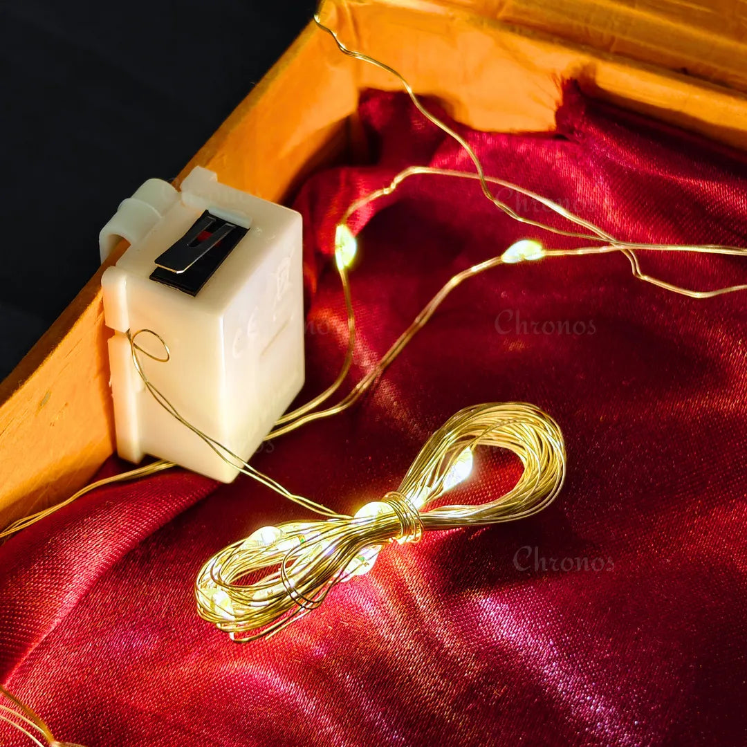 Close-up of warm white LED lights glowing during a gift box unboxing moment.